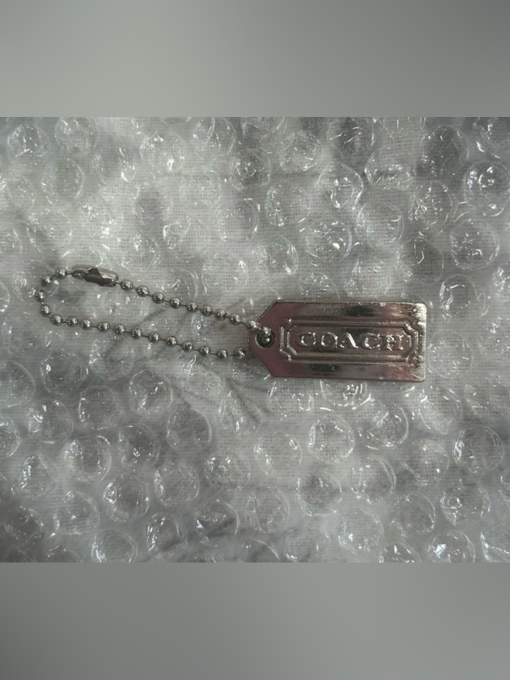 Coach Authentic Silver/Metallic Rectangular Logo Hang Tag. EUC